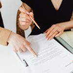 Two business professionals reviewing documents together.