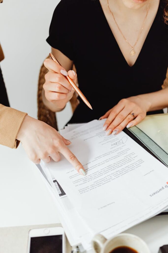 Crafting Captivating Headlines: Your awesome post title goes here Two business professionals reviewing documents together.